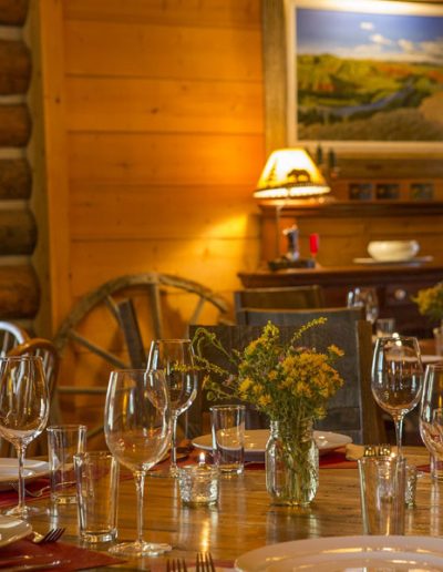 Log Cabin Dining Room with table set for dinner - Lazy L&B Dude Ranch Wyoming