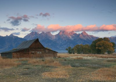 T.A. Moulton Barn at sunrise during fall with the Teton Range - Lazy L&B Ranch Wyoming