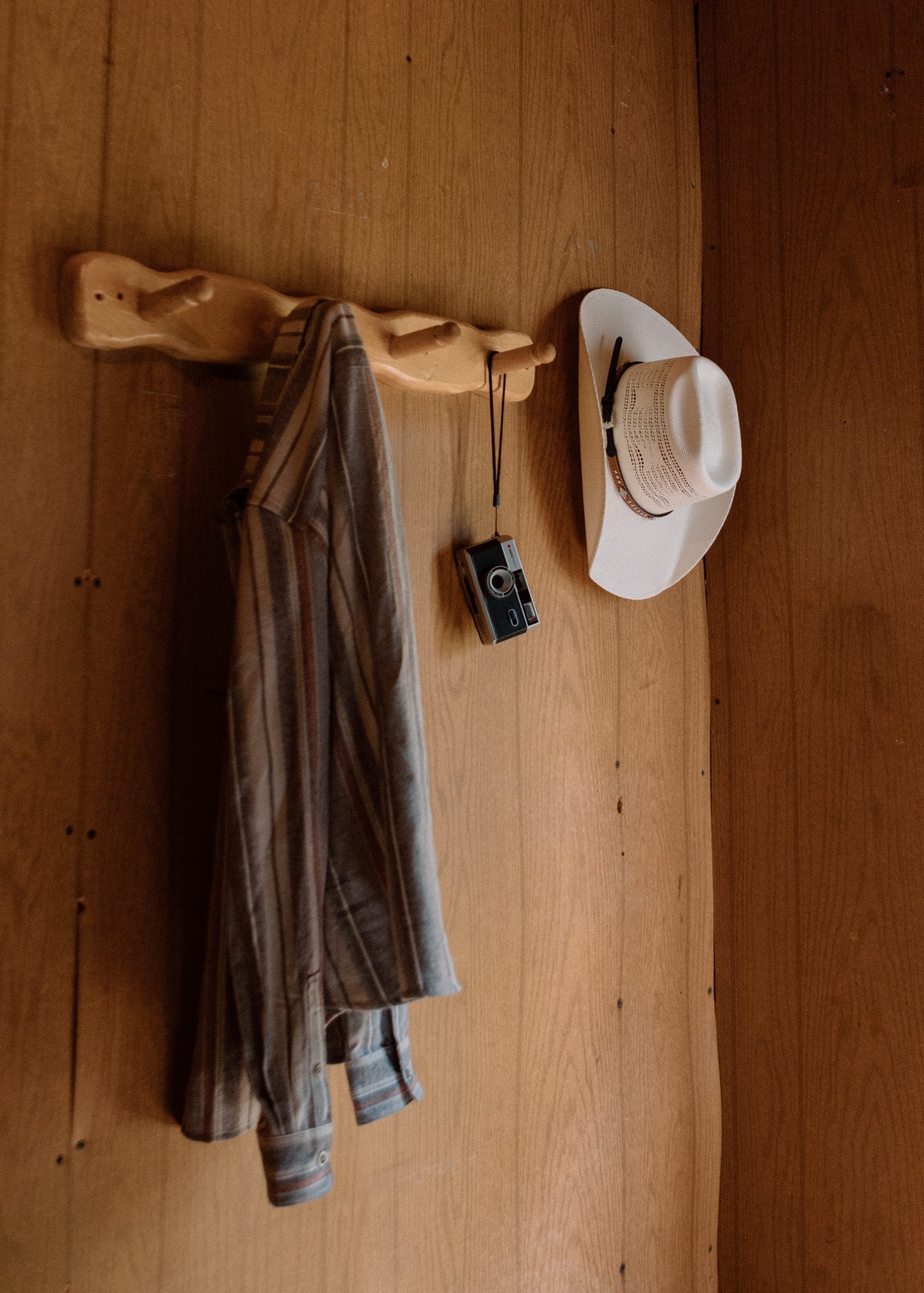 Western shirt, cowboy hat, and camera - essential items for dude ranch packing